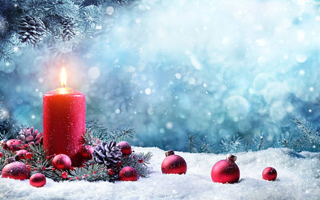 Advent Candle With Fir Branches Burning In Snowy Scene